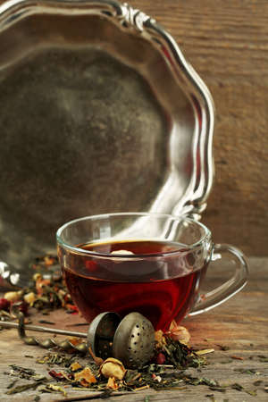 Beautiful vintage composition with herbal tea, on wooden tableの写真素材