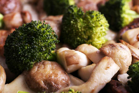 Braised wild mushrooms with vegetables and spices close-up backgroundの写真素材