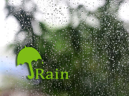 Water drops with umbrella signの写真素材
