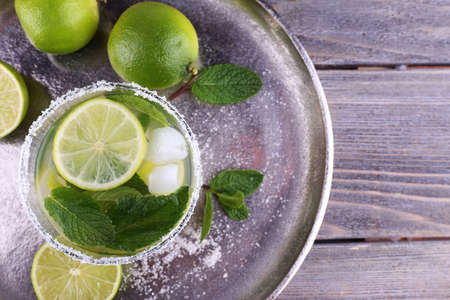 Lemonade in glass on tray on wooden backgroundの写真素材