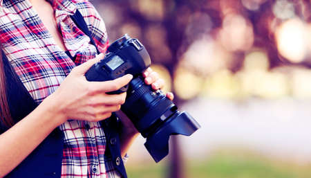 Young photographer taking photos outdoorsの写真素材