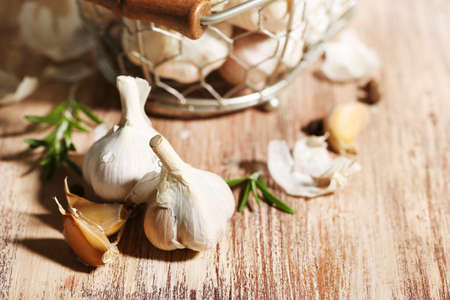 Raw garlic and spices on wooden tableの写真素材