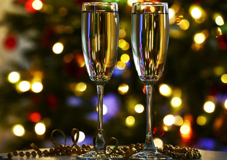 Champagne glasses on table, on fir-tree backgroundの写真素材