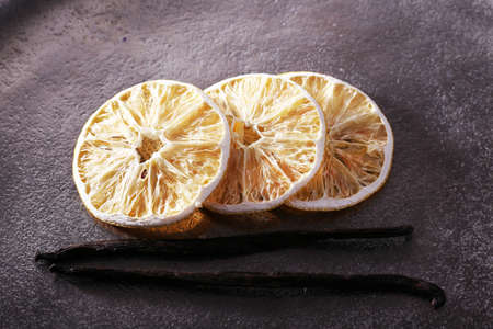Dried slices of with vanilla beans on metal backgroundの写真素材