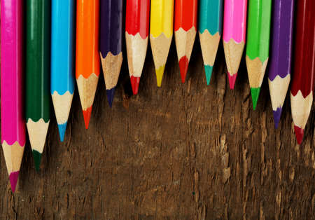 Colorful pencils on rustic wooden backgroundの写真素材