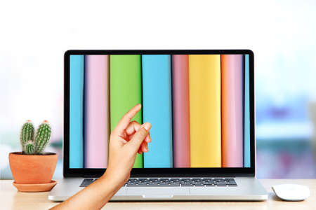 E-learning concept.  Digital library - books inside laptopの写真素材