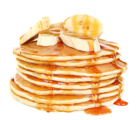 Stack of delicious pancakes with slices of banana and honey on plate isolated on whiteの写真素材