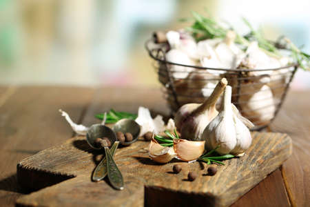 Raw garlic and spices on wooden tableの写真素材