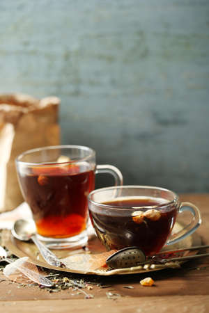Beautiful vintage composition with herbal tea, on wooden tableの写真素材