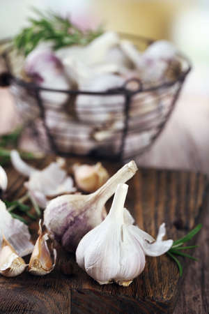 Raw garlic and spices on wooden tableの写真素材