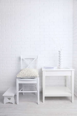 Modern interior with chair and pillow on white brick wall backgroundの写真素材