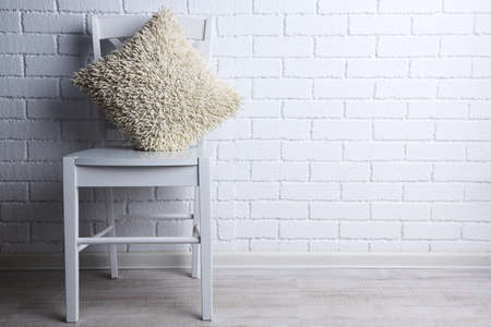 Modern interior with chair and pillow on white brick wall backgroundの写真素材