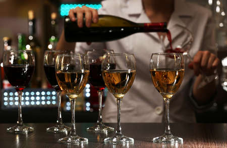 Bartender working at counter on bar backgroundの写真素材