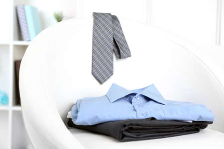 Men's clothes on chair with shelf on backgroundの写真素材