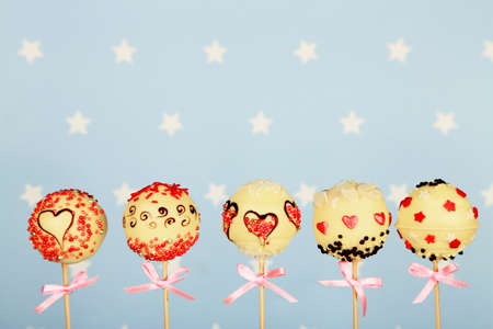 Tasty cake pops on blue backgroundの写真素材