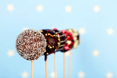 Tasty cake pops on blue backgroundの写真素材