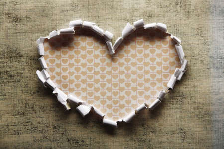 Torn paper heart over colorful backgroundの写真素材