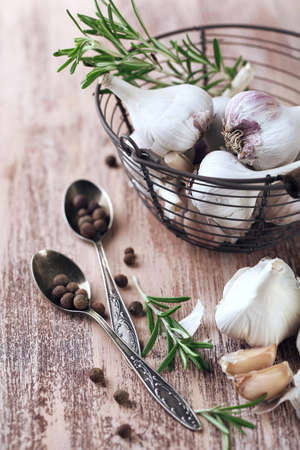 Raw garlic and spices on wooden tableの写真素材