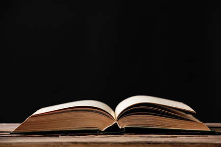 Open book with light over dark backgroundの写真素材