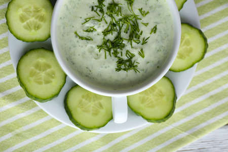 Cucumber soup in bowl on color wooden table backgroundの写真素材