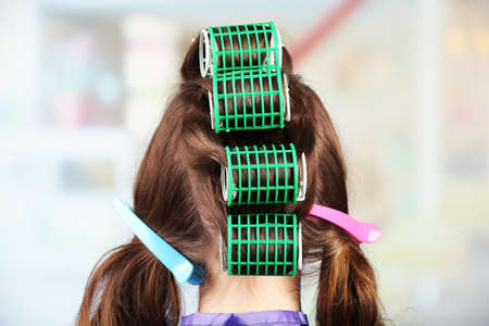 Long female hair during hair dressing with curler, close-upの写真素材