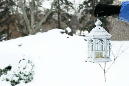 Hanging lantern on snowfall backgroundの写真素材
