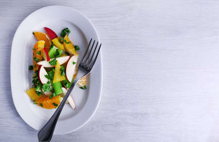 Waldorf salad with orange on plate on table close upの写真素材