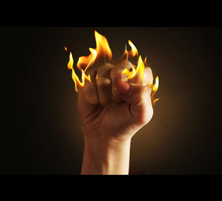 Burning fist isolated on blackの写真素材
