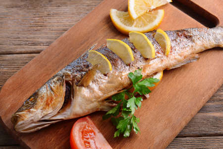 Tasty baked fish on table close-upの写真素材