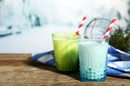 Fresh milk with natural decor, on wooden table, on winter backgroundの写真素材