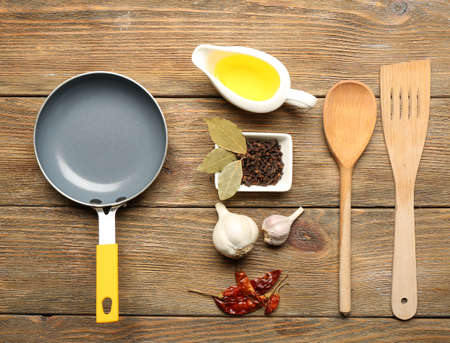 Food ingredients and kitchen utensils for cooking on wooden backgroundの写真素材