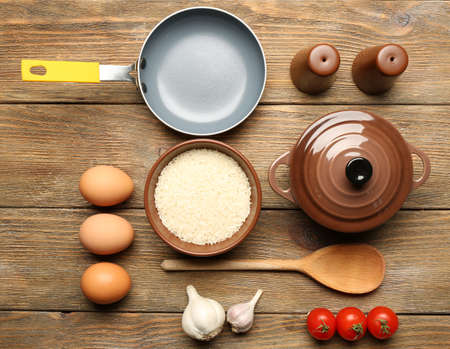 Food ingredients and kitchen utensils for cooking on wooden backgroundの写真素材