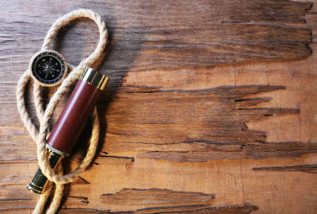 Marine still life spyglass, compass and rope on wooden backgroundの写真素材