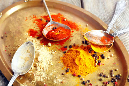 Various of spices on metal tray and rustic wooden table backgroundの写真素材