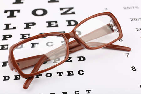 Eye glasses on eyesight test chart backgroundの写真素材