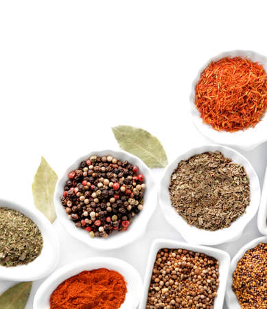 Different kinds of spices in ceramics bowls isolated on whiteの写真素材
