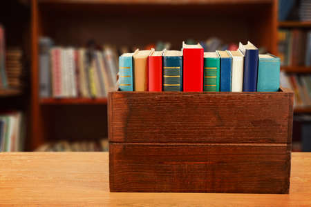 Books in wooden crate on bookshelves backgroundの写真素材