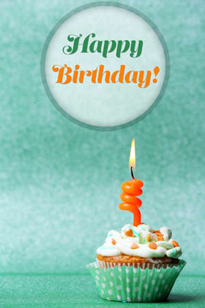 Delicious birthday cupcake on green backgroundの写真素材