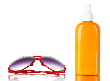 Bottle of suntan cream with sunglasses isolated on whiteの写真素材