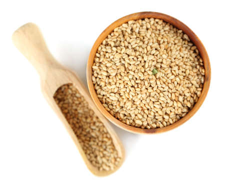 Sesame in wooden bowl, isolated on whiteの写真素材