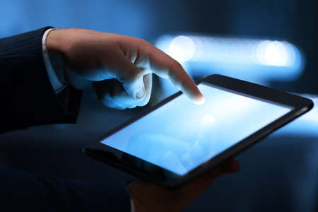 Male hand touching screen tablet close-upの写真素材