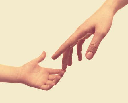 Child and mother hands on light background