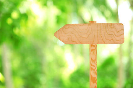 Wooden sign arrow on nature backgroundの写真素材