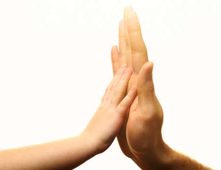 Child and mother hands together on light backgroundの写真素材
