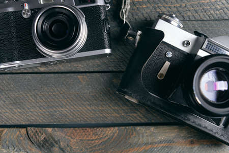 Old retro cameras on rustic wooden planks backgroundの写真素材