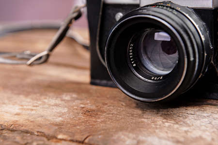 Old retro camera on rustic wooden planks backgroundの写真素材