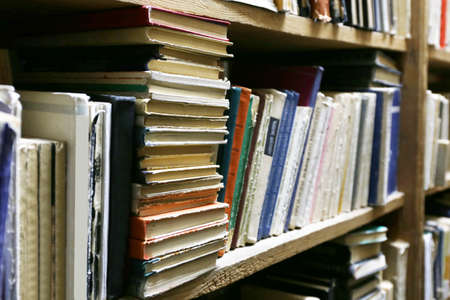 Many books on bookshelf in libraryの写真素材