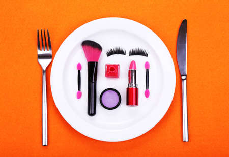 Makeup accessories on plate on colorful backgroundの写真素材