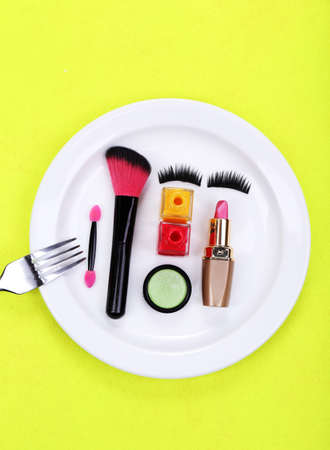Makeup accessories on plate on colorful backgroundの写真素材