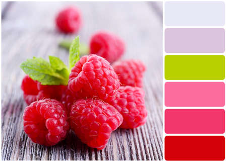 Ripe sweet raspberries on table and palette of colorsの写真素材